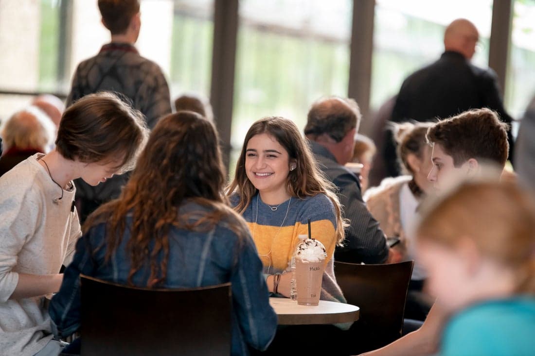 Group of girls smiling and eating