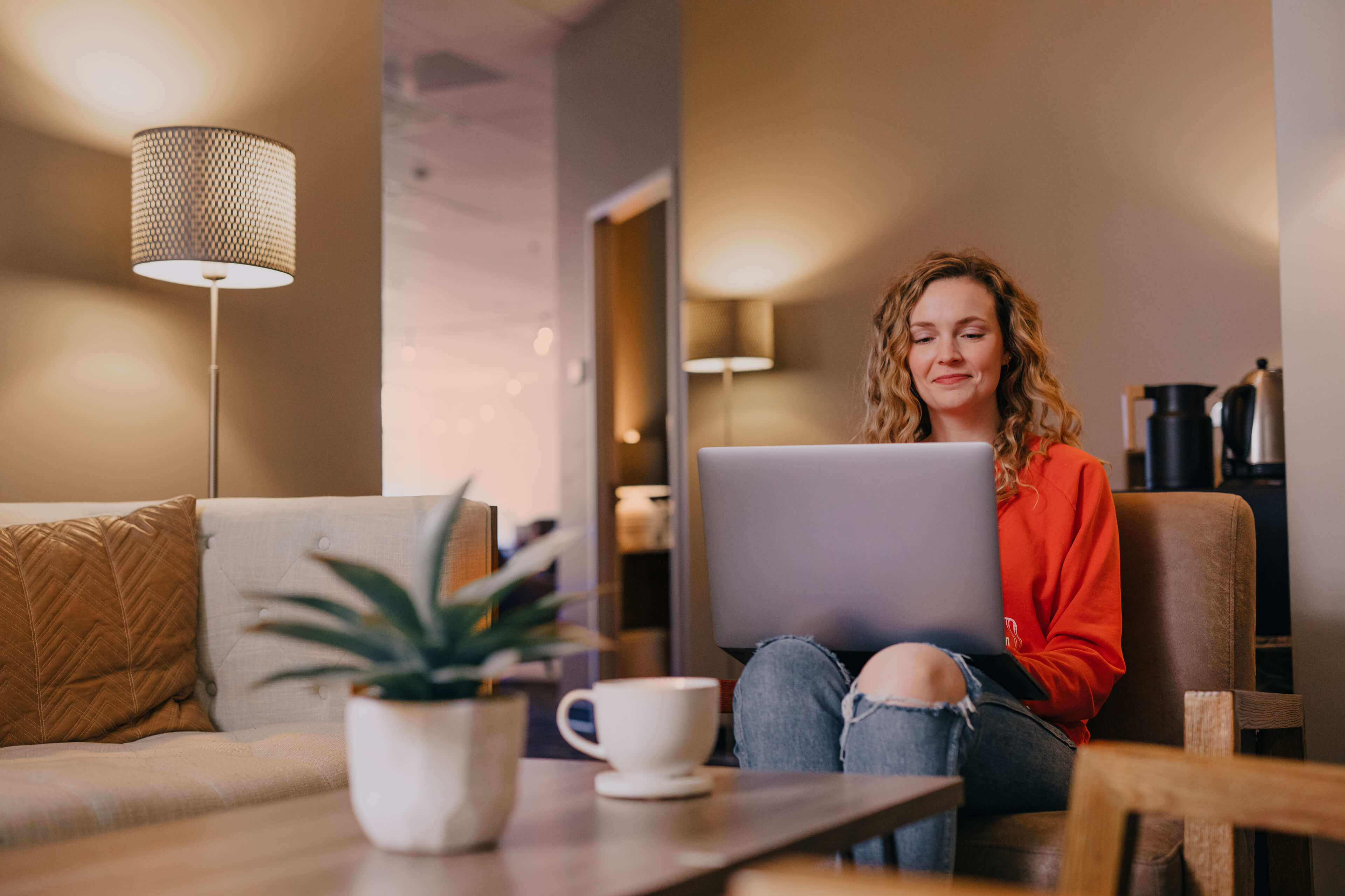 Woman in a chair looking at a laptop