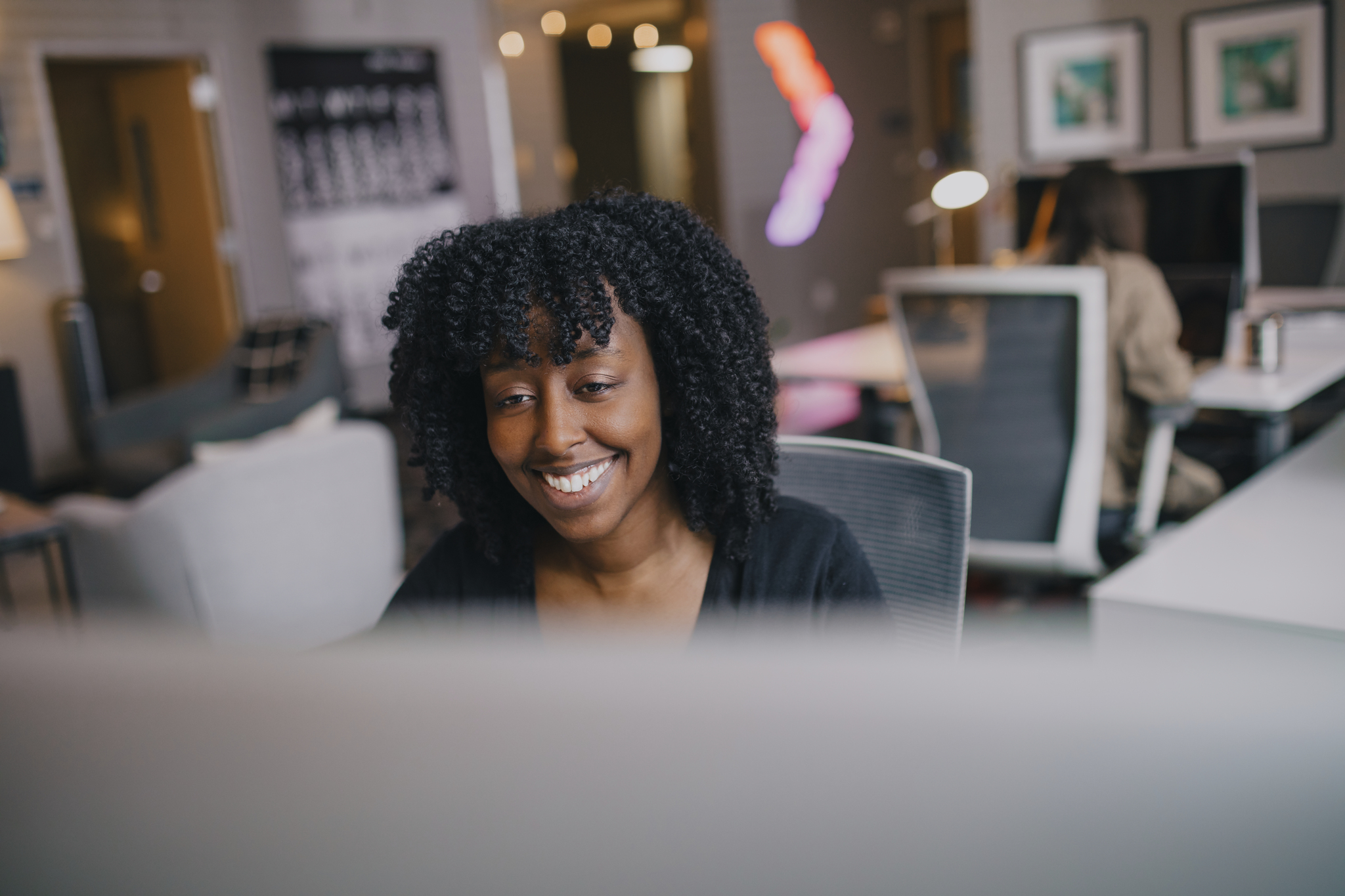 Woman smiling looking at a computer